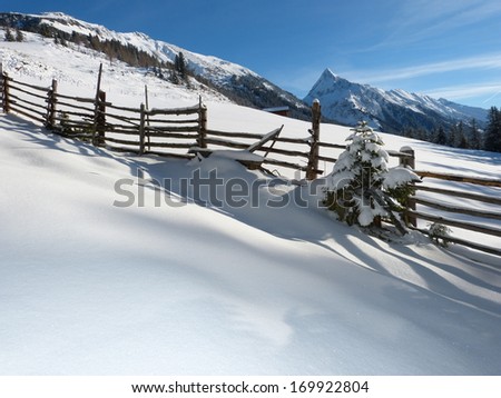 Wooden fence in winter landscape