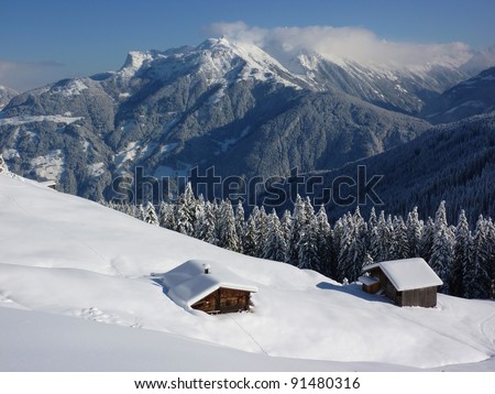 Log cabins in winter landscape