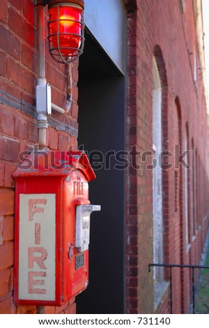 Fire alarm call box on factory wall