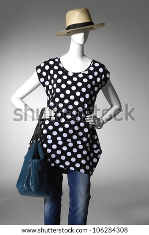 fashion female clothing in jeans with bag on mannequin in light background