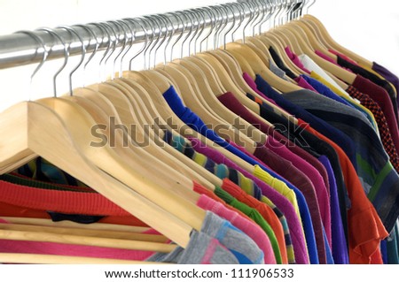 Set of multi colored shirts on hangers against a white