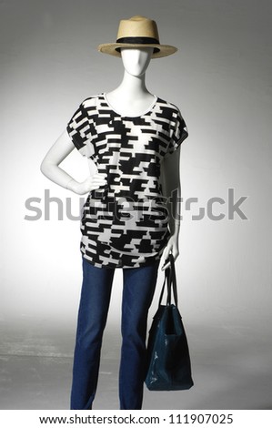 Mannequin in jeans with bag on light background