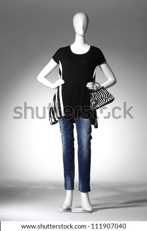 full-length collection of dress with bag on mannequin in light background