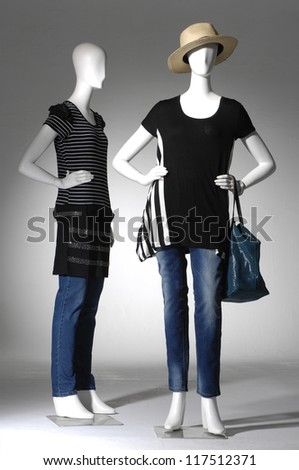 female clothing in jeans with bag on two mannequin