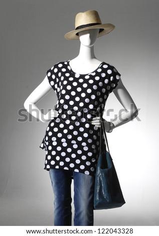 female clothing in hat with bag on mannequin in light background