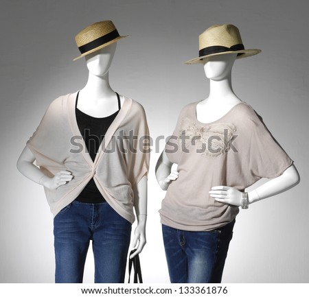 Two Fashion clothes in hat with bag on a mannequin