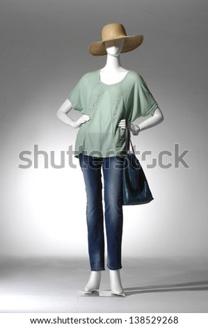 full-length female clothing in jeans with bag on mannequin in light background