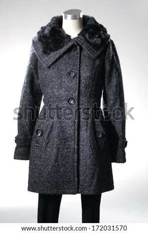 Isolated female coat dress in trousers on mannequin