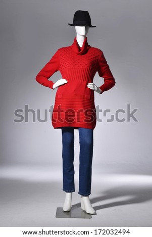 Full length Fashion female red clothing in hat on mannequin in light background