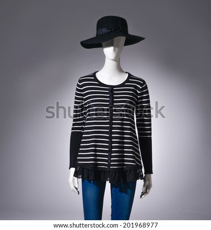 female striped shirt clothing in black hat on mannequin