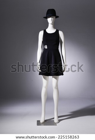 full-length female clothing in black dress with black hat on mannequin