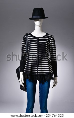 female striped shirt clothing in black hat,bag on mannequin