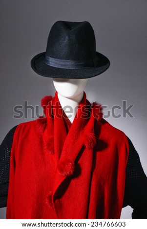 female red clothing in black hat on mannequin