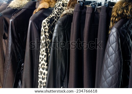 Variety of female different autumn/winter clothing hanging on hangers