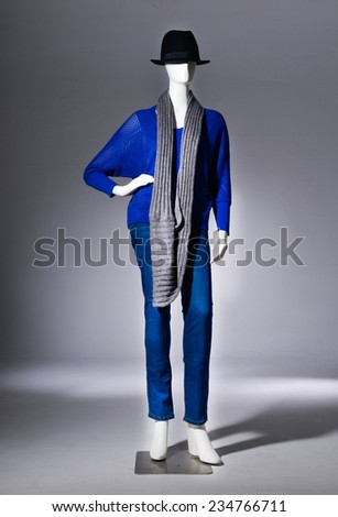 female blue clothing in jeans with black hat ,scarf on mannequin on gray background