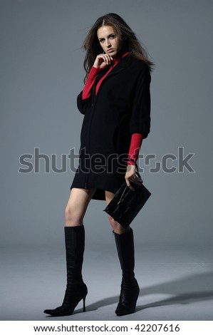 Vogue style photo of fashion model holding little purse