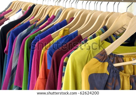 Line of colorful shirt rack on white