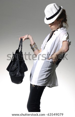 stock photo : Fashion model wearing the big modern sunglasses with bag