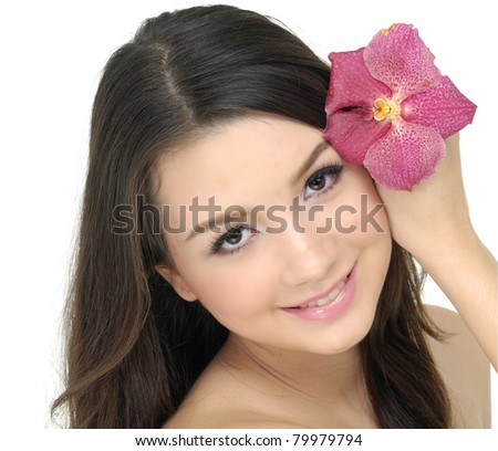 Close up beautiful woman with orchid in her hair
