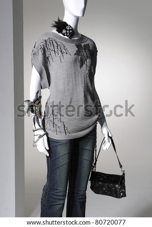 Fashion clothes on a mannequin holding bag