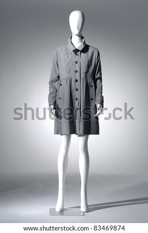 Fashion coat clothes on a mannequin in light background