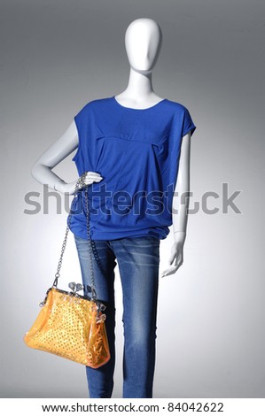 Mannequin dressed in jeans with bag, isolated