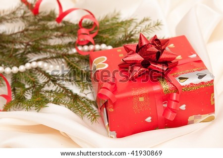 Red box with present on a background of a New Year tree