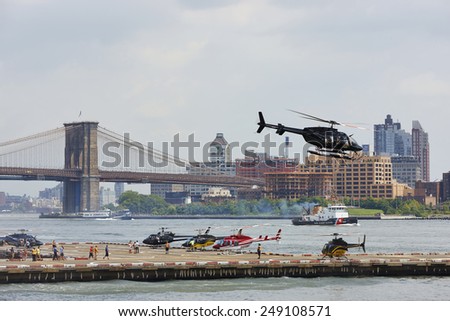Helicopters leaving for sight-seeing tours above New York City, U.S.A., Downtown Manhattan Heliport, August 4th 2014, 1:09 p.m.