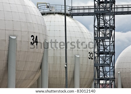 tanks in oil refinery factory on the cloudy sky