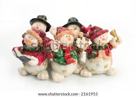 miniature Snowman statues in different poses against white background with clipping paths
