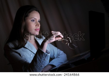 Beautiful lady is surfing the internet late