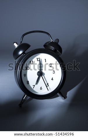 an alarm clock on grey/dark background