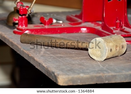 Old wooden mallet on an antique tool bench