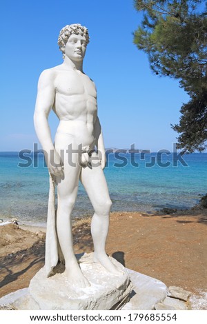Ancient greek statue of a young athlete by the sea
