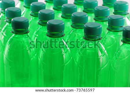 Green plastic bottles in a row