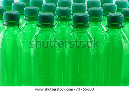 Green plastic bottles in a row