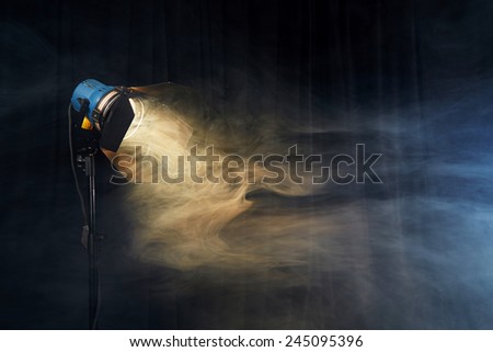 Photo studio lighting equipment on black background with smoke