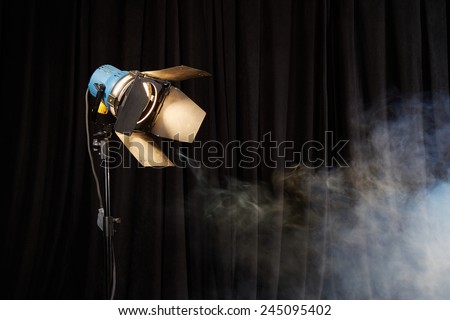 Photo studio lighting equipment on black background with smoke