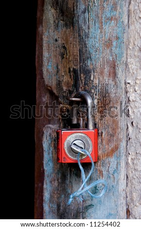 Old padlock on a wooden door
