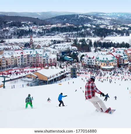 Mont-Tremblant, Qc, Canada -February 9: Skiers And Snowboarders Are Sliding Down The Main Slope At Mont-Tremblant Ski Resort On February 9, 2014. It Is The Best Ski Resort In Eastern North America.