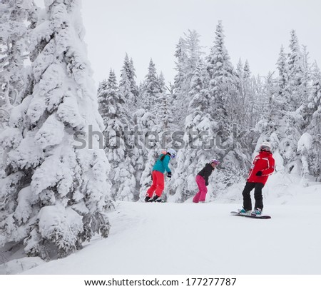 MONT-TREMBLANT, QC, CANADA -FEBRUARY 9: Snowboarders are sliding down an easy slope at Mont-Tremblant Ski Resort on February 9, 2014. It is the best ski resort in Eastern North America.