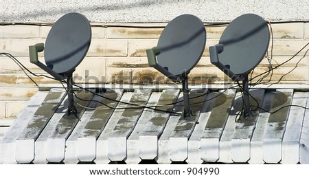 Three Satellite Dishes on a Small Overhang 1
