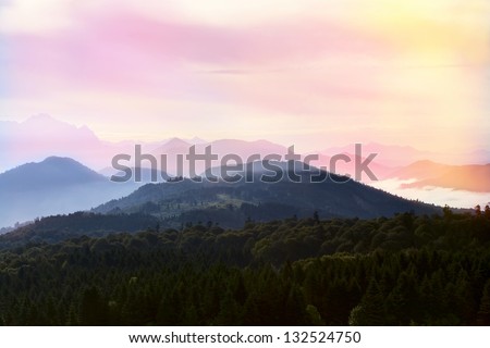 Orange sunset in mountains. Beautiful landscape mountain panorama