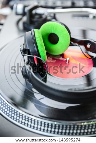 Dj mixer and Vinyl Player with headphones at club. Soft focus