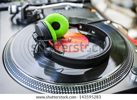Dj mixer and Vinyl Player with headphones at club. Soft focus