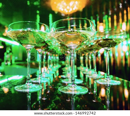 Glasses of champagne at the bar in festive evening. Soft focus