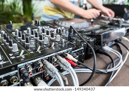 Dj mixes track on Vinyl Player in club at party. Soft focus