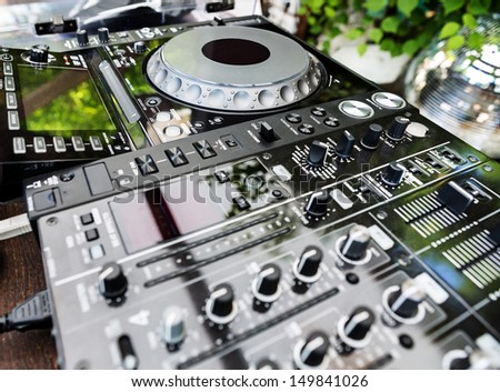 DJ CD player and mixer in a nightclub in daylight