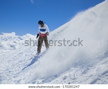 Freerider snowboarder moving down in snow powder