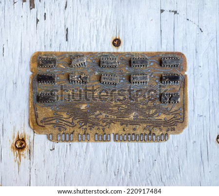 Old controller computer circuit board from a mainframe computer manufactured.  Strong and evident defect chips on background of the old painted surface